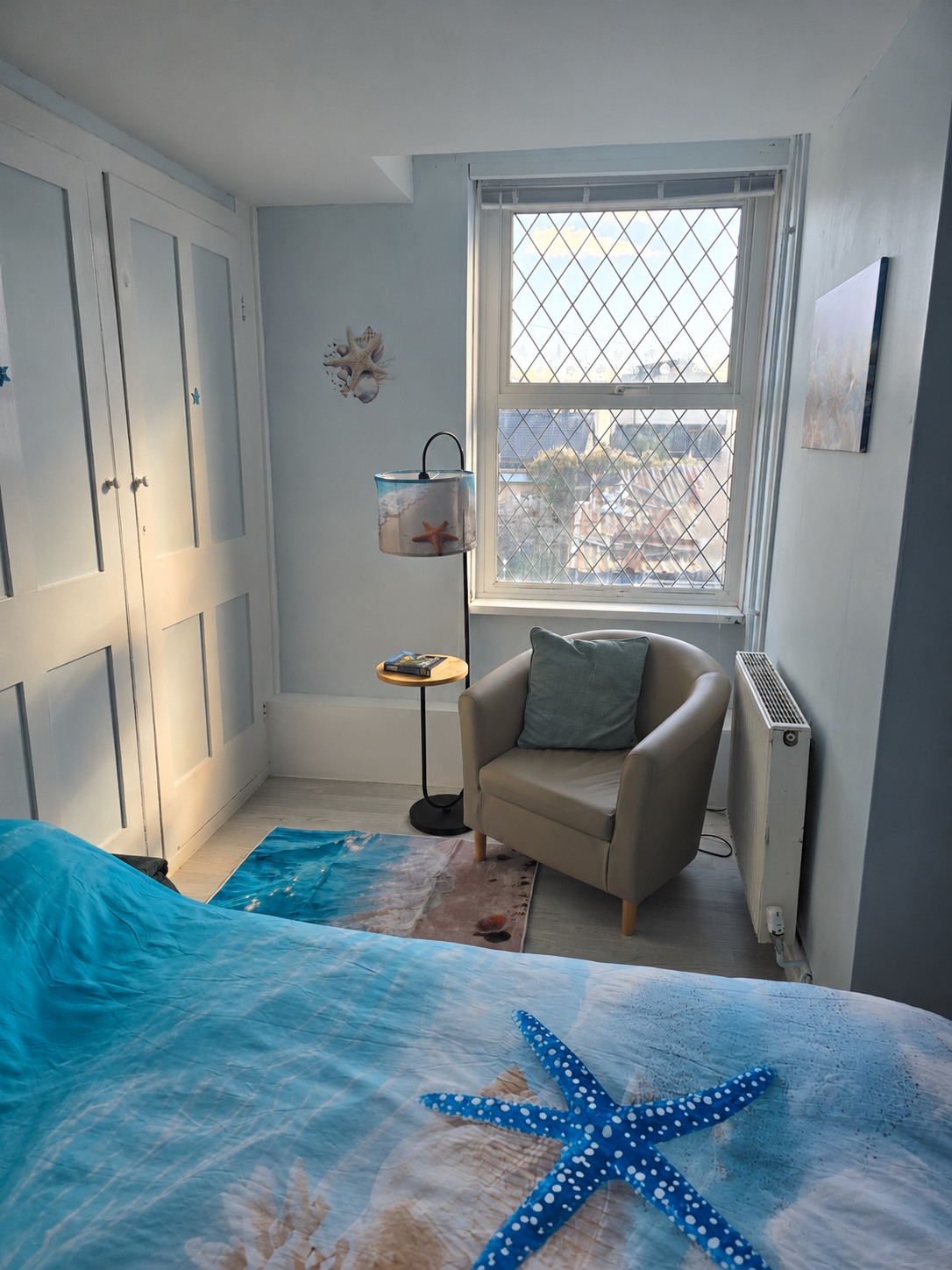 Starfish room with a flatter, neatly made bed